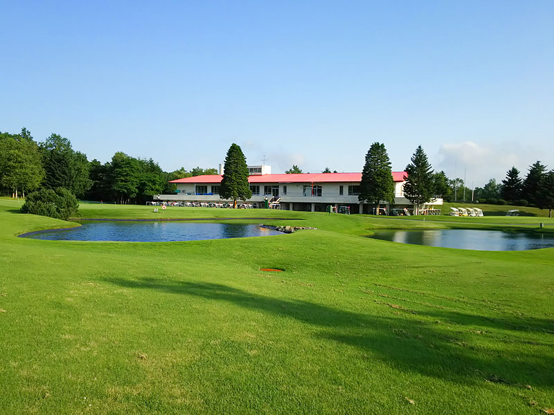 The clubhouse at Chitose Country Club seen across a pond